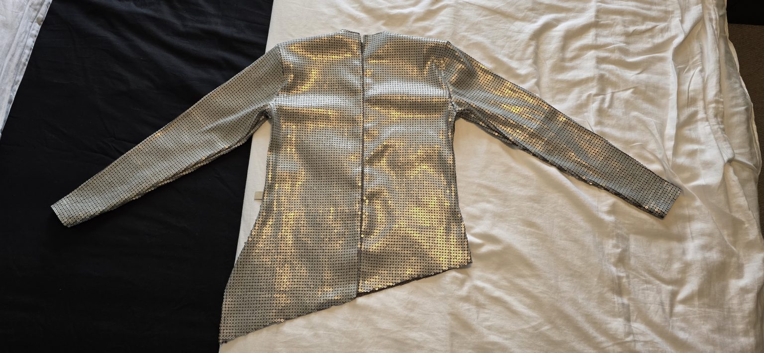The invisible zipper on the back of a custom Ophelia-inspired sequin dress bodice, before the hip band attachment.
